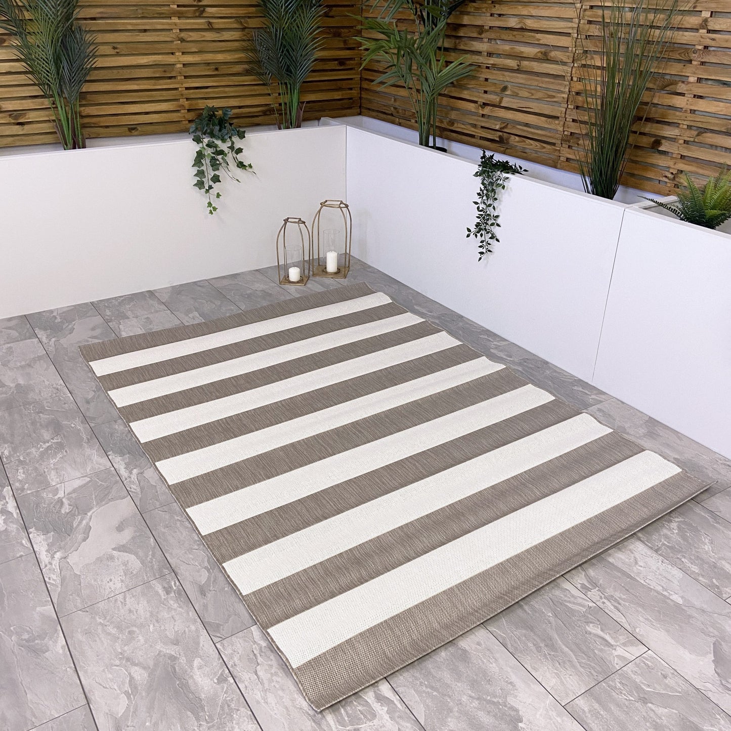 The chic and minimal beige and cream stripe outdoor rug with a muted beige chunky line design is an ideal choice for modern outdoor living.