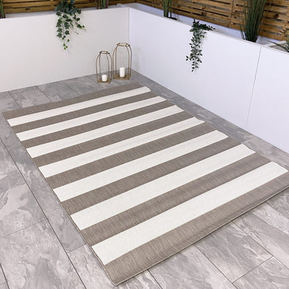 The chic and minimal beige and cream stripe outdoor rug with a muted beige chunky line design is an ideal choice for modern outdoor living.